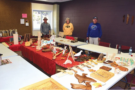Woodcarvers with their crafts displayed